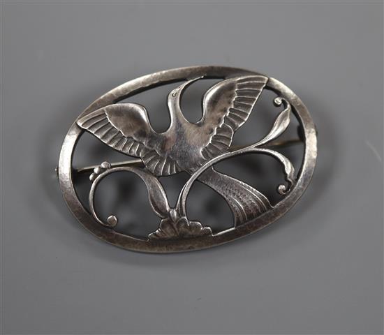 A post 1945 Georg Jensen 925 pierced oval brooch, decorated with a bird in flight, design no. 238, 43mm, 10 grams.